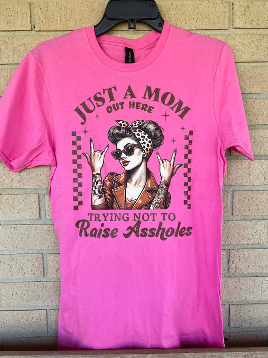 Just a mom out here trying not to raise assholes tee