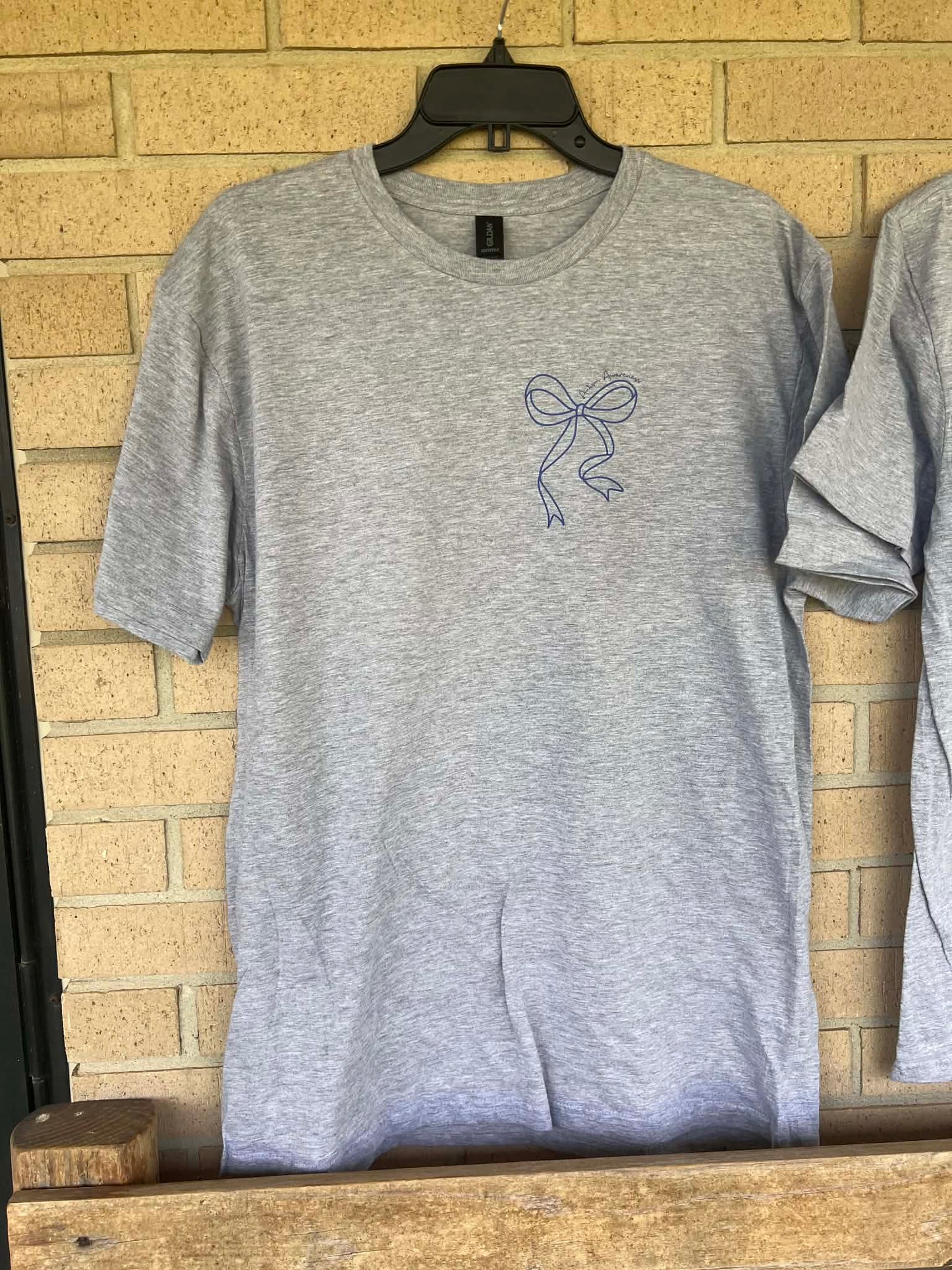 In April we wear blue dainty bow pocket tee